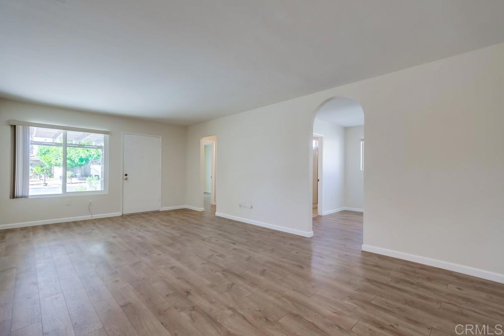 1376 Panorama Ridge Road Oceanside, CA 92056 - Photo 8 of 50 an empty room with wooden floor and windows
