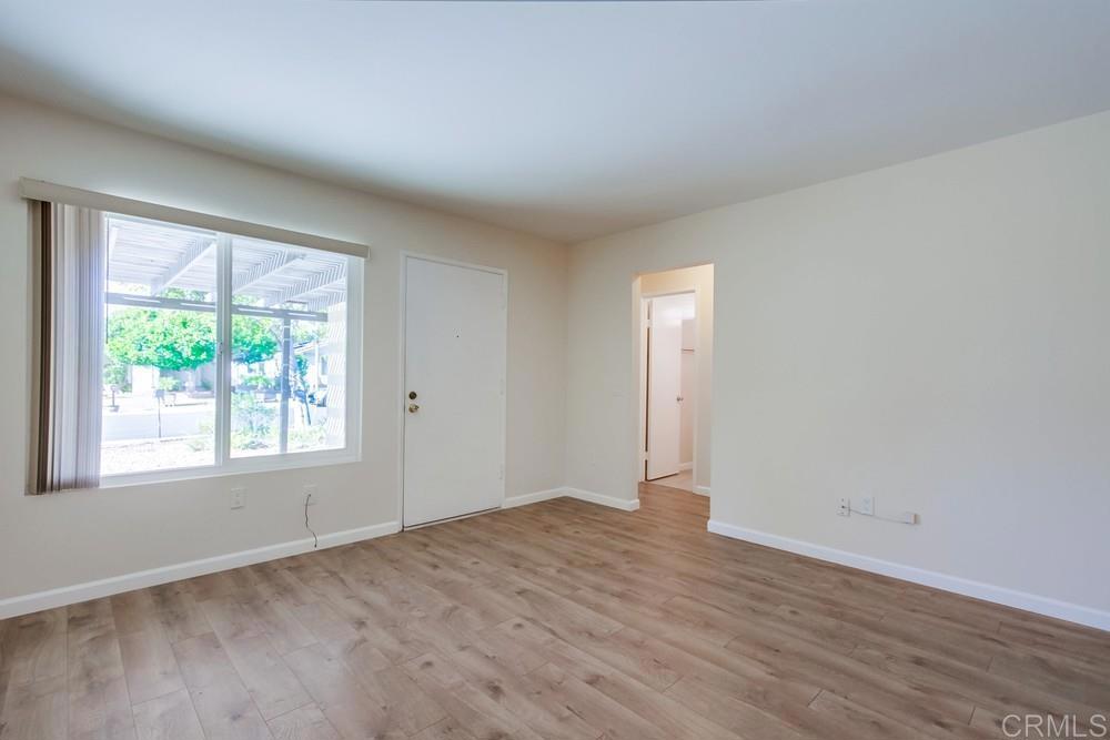 1376 Panorama Ridge Road Oceanside, CA 92056 - Photo 10 of 50 an empty room with wooden floor and windows