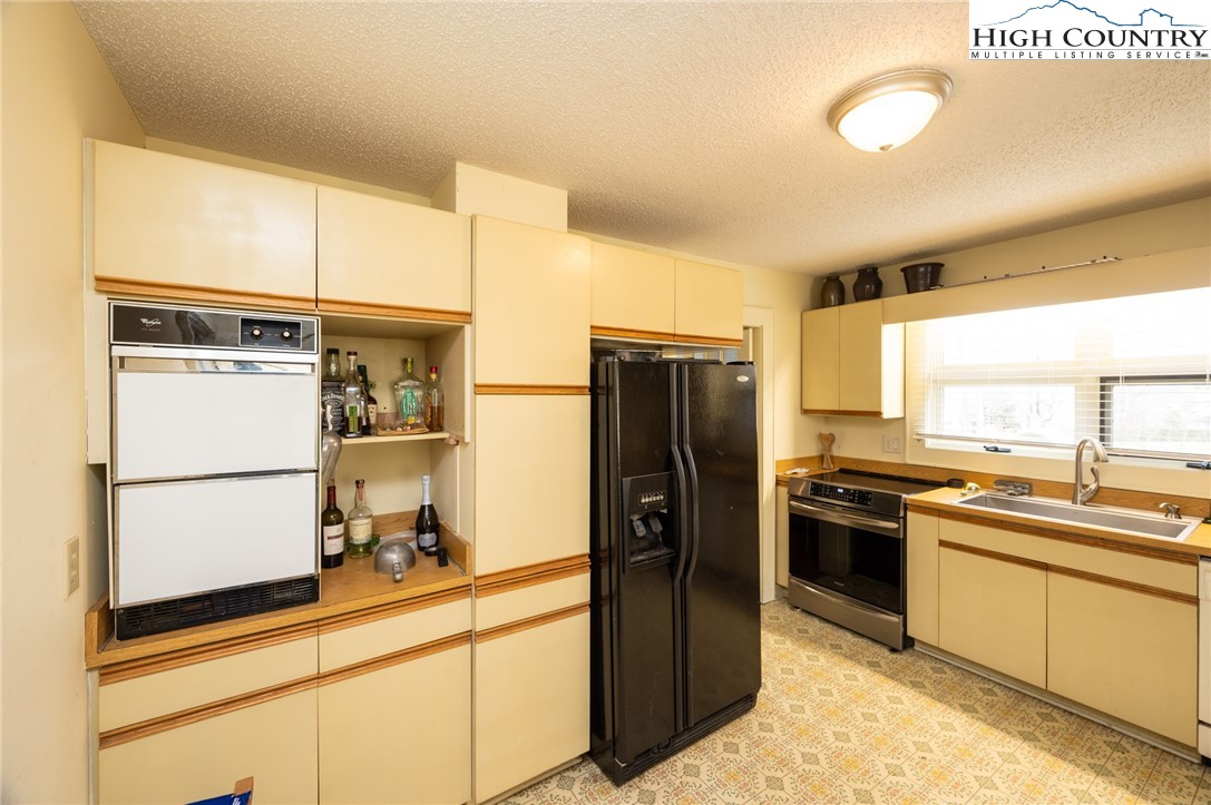 4634 Highway 421 Vilas, NC 28692 - Photo 20 of 28 a kitchen with a refrigerator and a sink