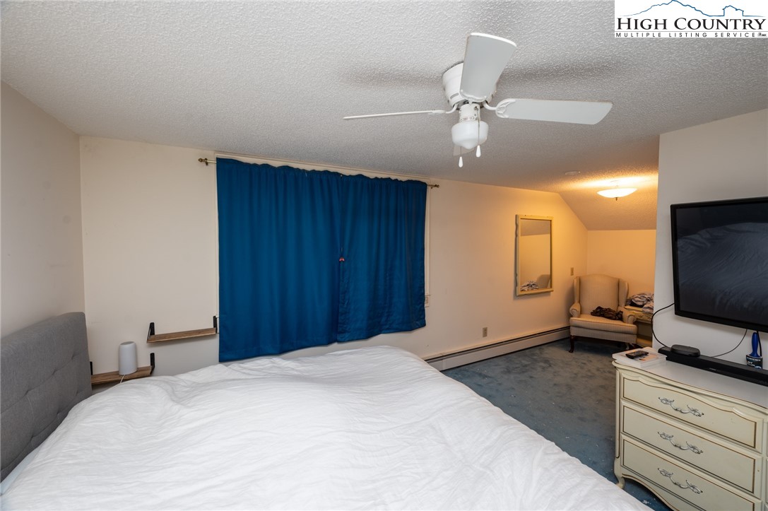 4634 Highway 421 Vilas, NC 28692 - Photo 27 of 28 a bedroom with a bed and a flat tv screen on dresser