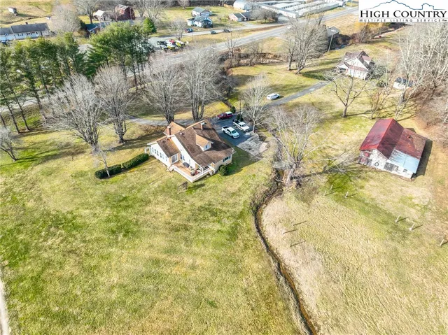 a white house that has a tree in front of it