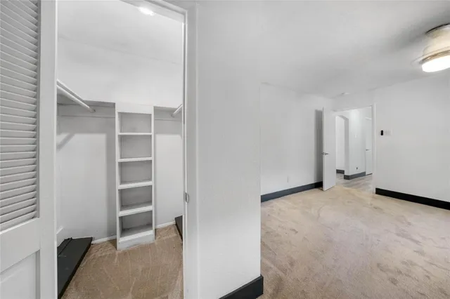 a large kitchen with a large counter top a sink a stove and cabinets