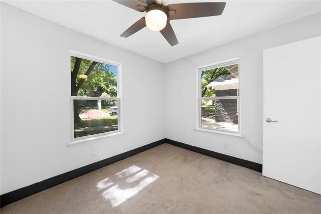 a kitchen with stainless steel appliances white cabinets a sink and a stove