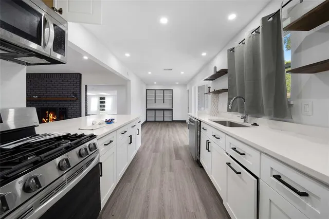 a view of a room with wooden floor and windows