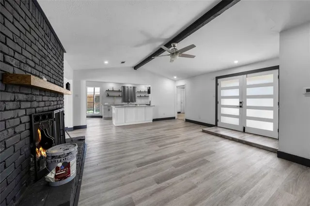 a view of a living room with furniture and a fireplace