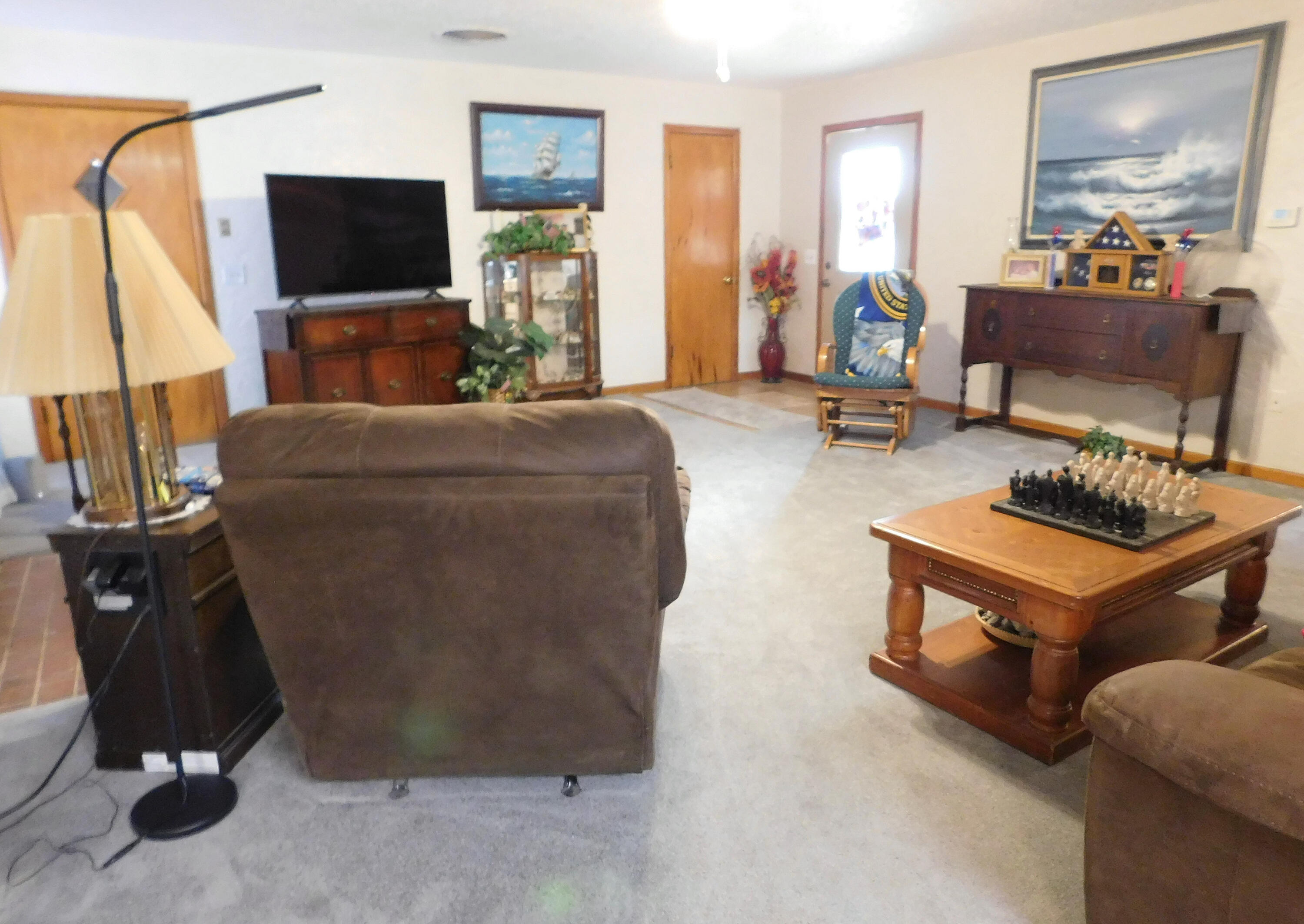 122 West 16th Street Muleshoe, TX 79347 - Photo 5 of 27 a living room with furniture a flat screen tv and a fireplace