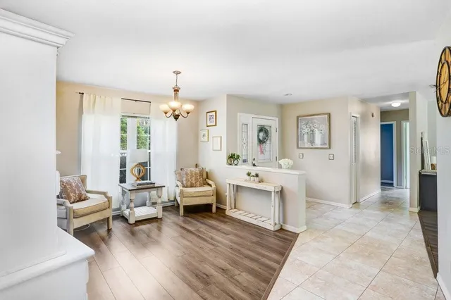 a spacious bedroom with a bed and a chandelier