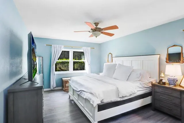 a large bed sitting in a bedroom next to a window