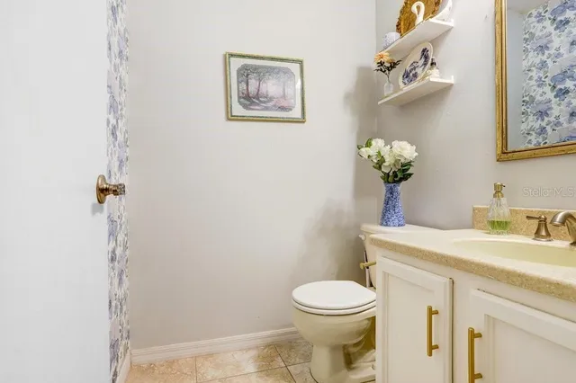 a bathroom with a toilet sink and vanity