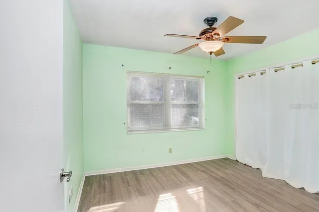 a view of room with a ceiling fan and window