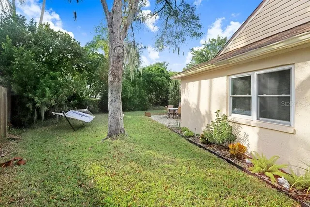 a view of a backyard with sitting area