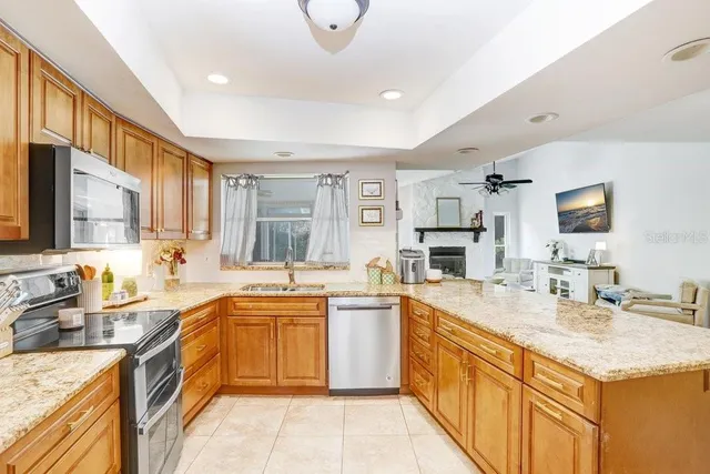 a kitchen with a sink stove top oven and cabinets
