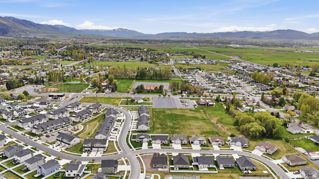 401 West 3085 South, Unit 329 Nibley, UT 84321 - Photo 29 of 34 Aerial view of residential area featuring a mountainous background