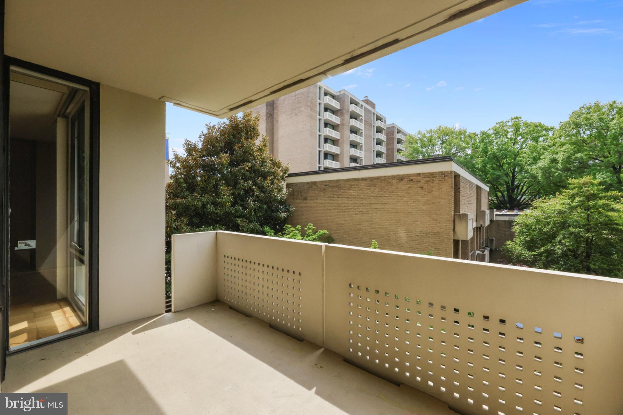 490 M Street Southwest, Unit W101 Washington, DC 20024 - Photo 15 of 25 Serene balcony with lush greenery views.