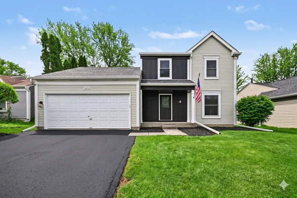 a front view of a house with a yard and garage