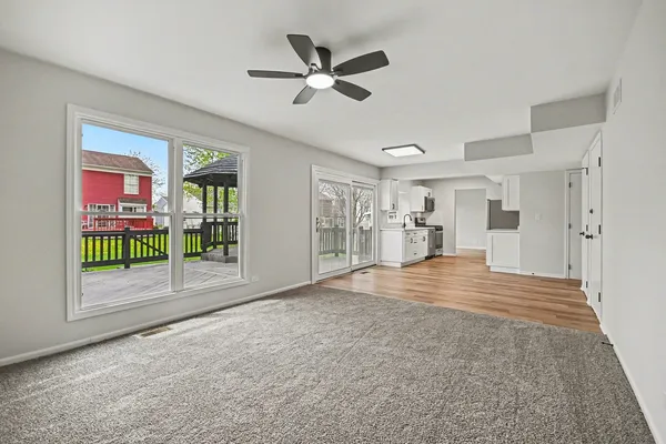 a view of empty room with a ceiling fan and window