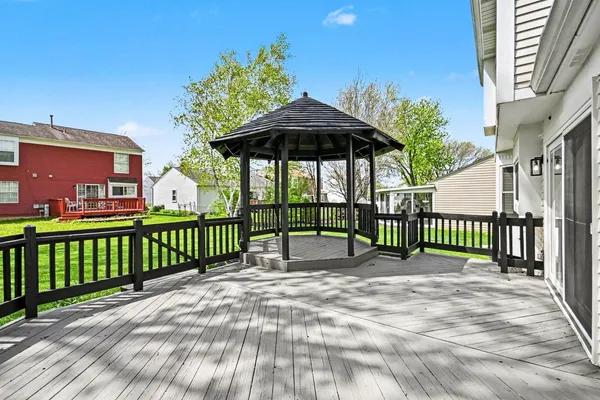 a view of a brick house with a small yard and furniture