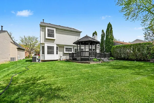 a view of a house with backyard sitting area and garden