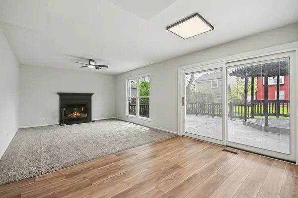 a view of an empty room with glass door and balcony