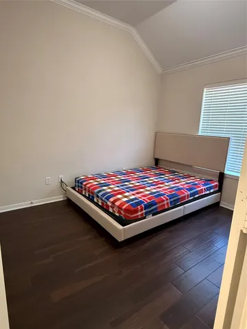 a view of a room with wooden floor and a window