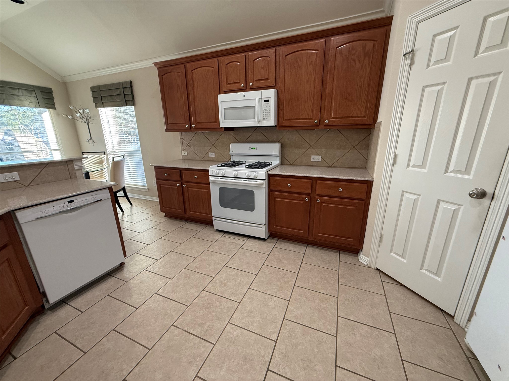 10002 Deer Track Court Houston, TX 77064 - Photo 5 of 15 a kitchen with stainless steel appliances a stove a sink and a refrigerator