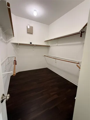 a view of wooden floor and windows in a room