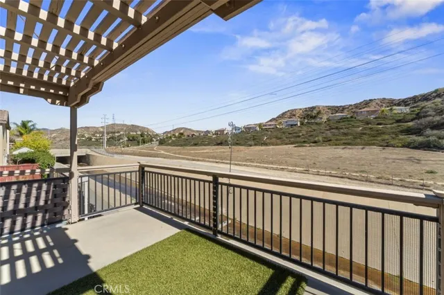 a view of a balcony with wooden floor and outdoor space