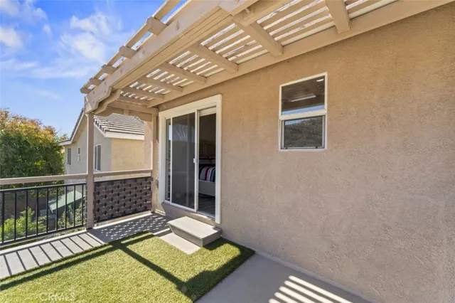 a view of a balcony with wooden floor and fence