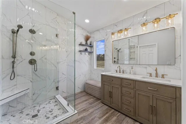 a spacious bathroom with a double vanity sink mirror and shower