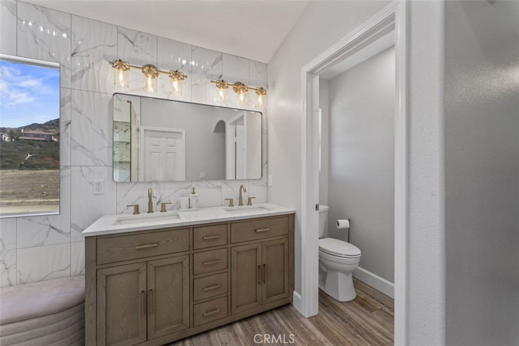 28340 Sycamore Drive Saugus, CA 91350 - Photo 17 of 34 a bathroom with a double vanity sink and mirror with toilet