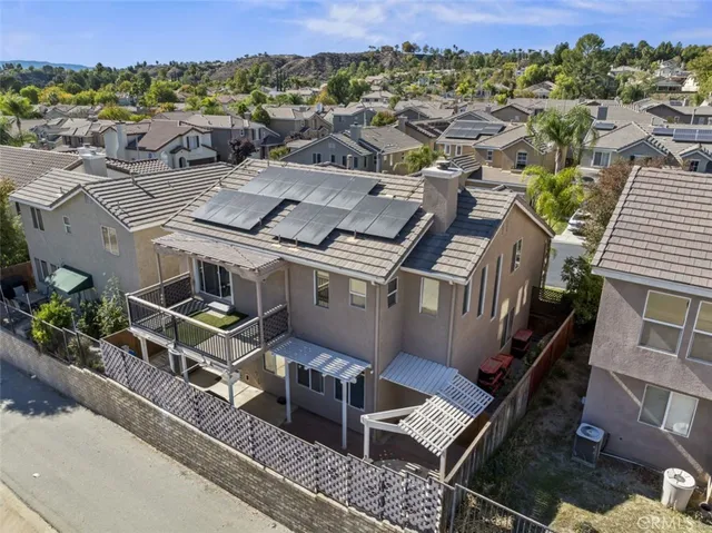 an aerial view of a house with a yard