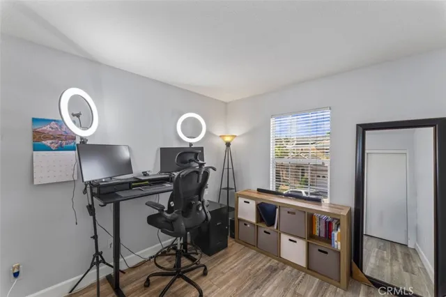 a view of a workspace with furniture and a window