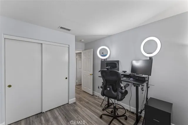 a view of a workspace with furniture and wooden floor