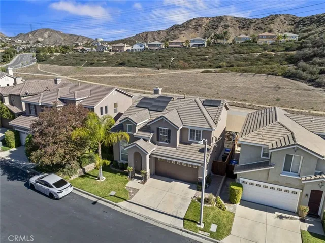 a aerial view of a house with a yard and balcony