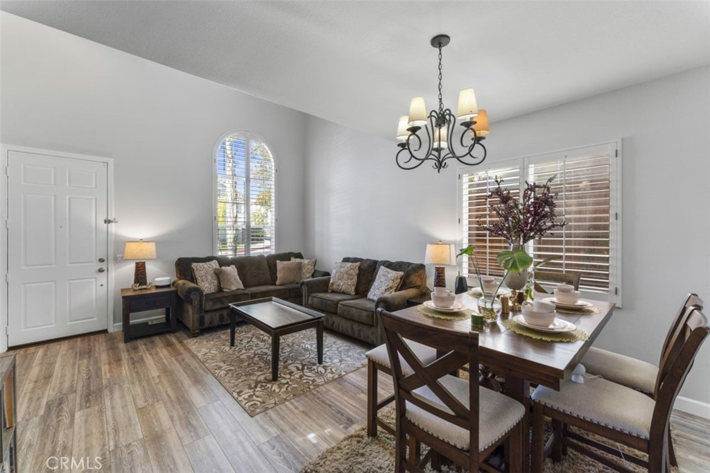 28340 Sycamore Drive Saugus, CA 91350 - Photo 4 of 34 a dining room with wooden floor a chandelier a glass table and chairs