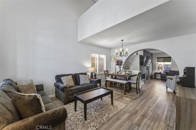 a living room with furniture and a chandelier