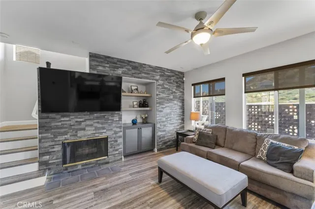 a living room with furniture fireplace and flat screen tv