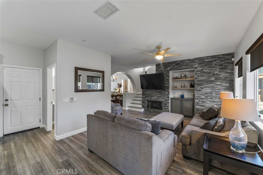 28340 Sycamore Drive Saugus, CA 91350 - Photo 7 of 34 a living room with furniture a ceiling fan and a flat screen tv