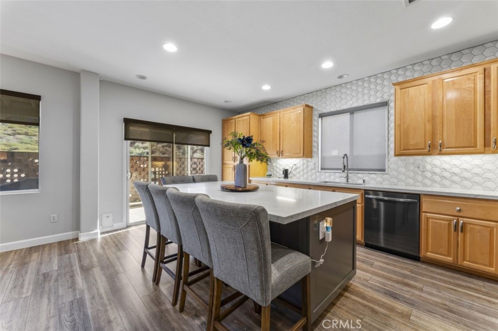 28340 Sycamore Drive Saugus, CA 91350 - Photo 10 of 34 a kitchen with stainless steel appliances granite countertop wooden floor a center island and a window
