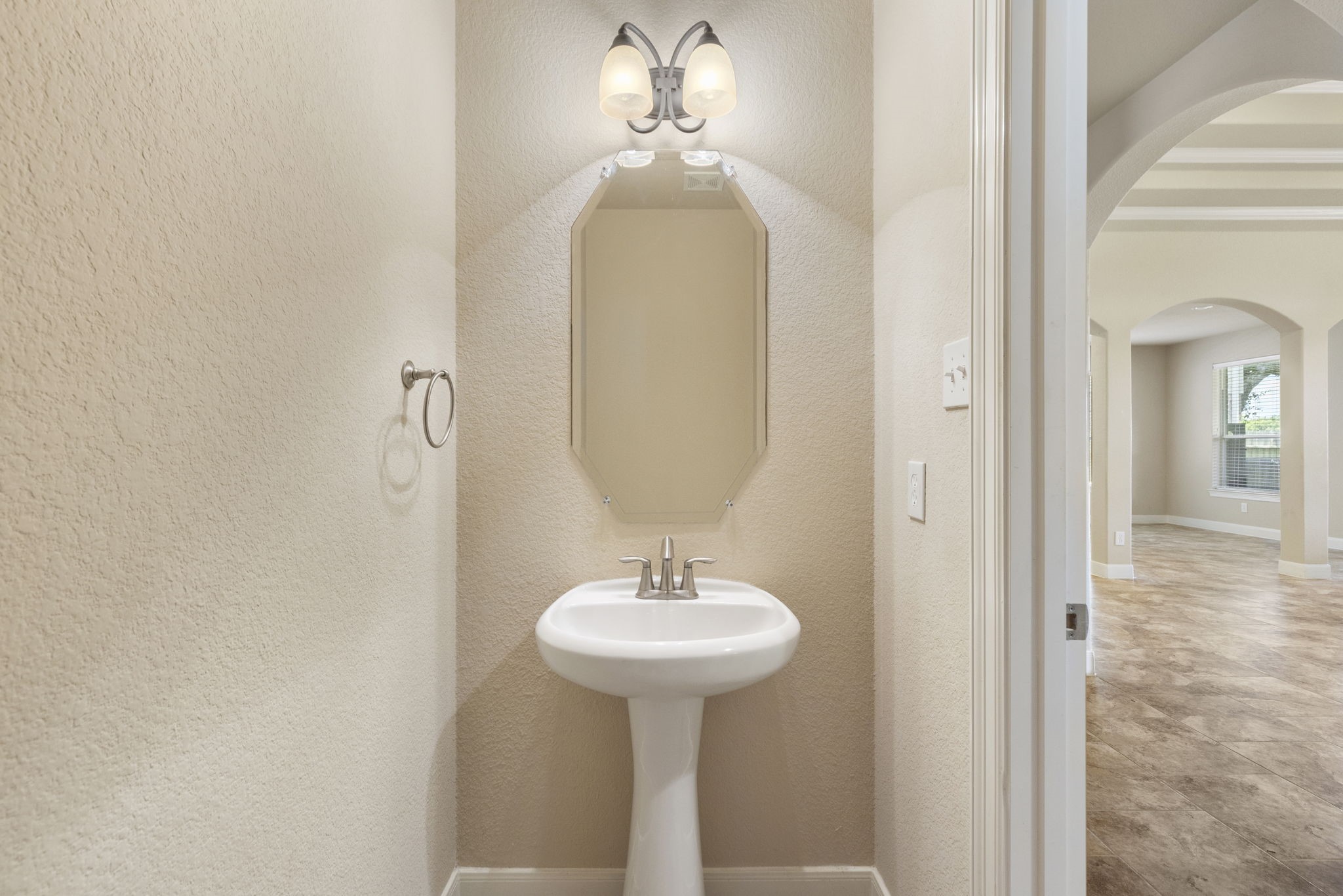 19222 Senterra Lakes Boulevard Spring, TX 77379 - Photo 31 of 45 Convenient half-bath/powder room on the main floor, featuring a classic pedestal sink and elegant lighting for guests.
