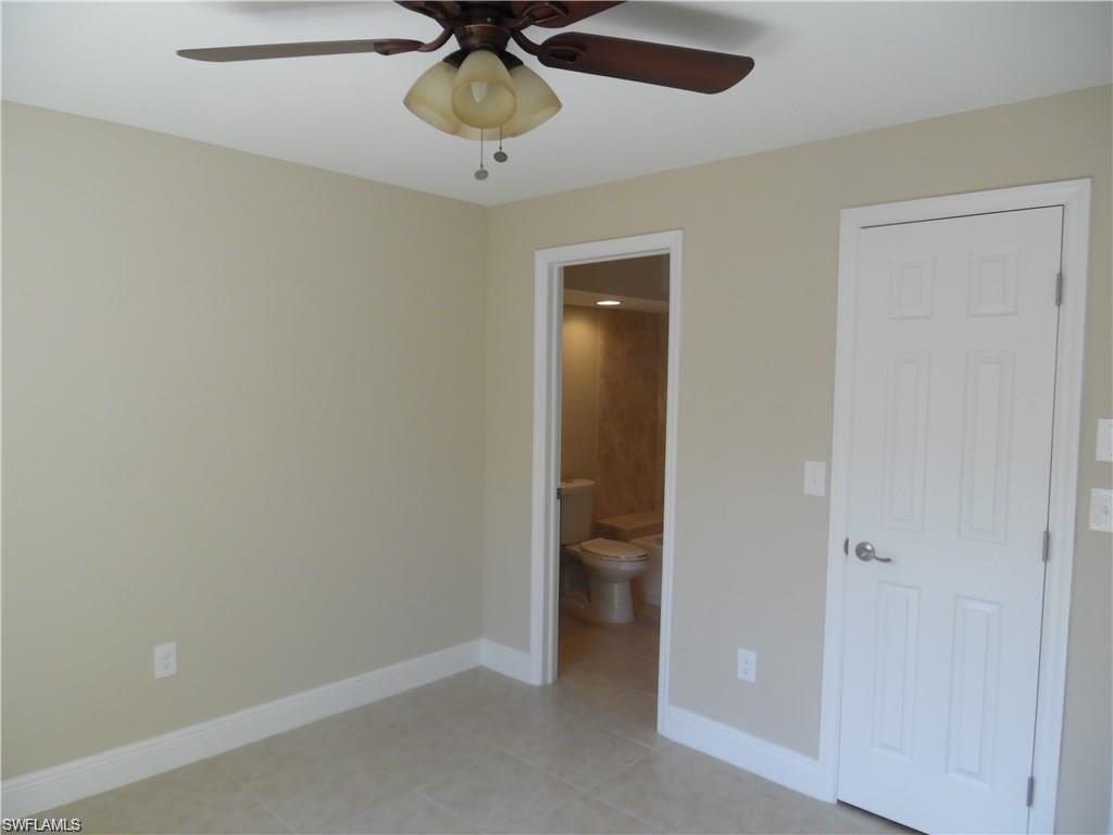 3055 52nd Street Southwest Naples, FL 34116 - Photo 11 of 21 an empty room and chandelier fan