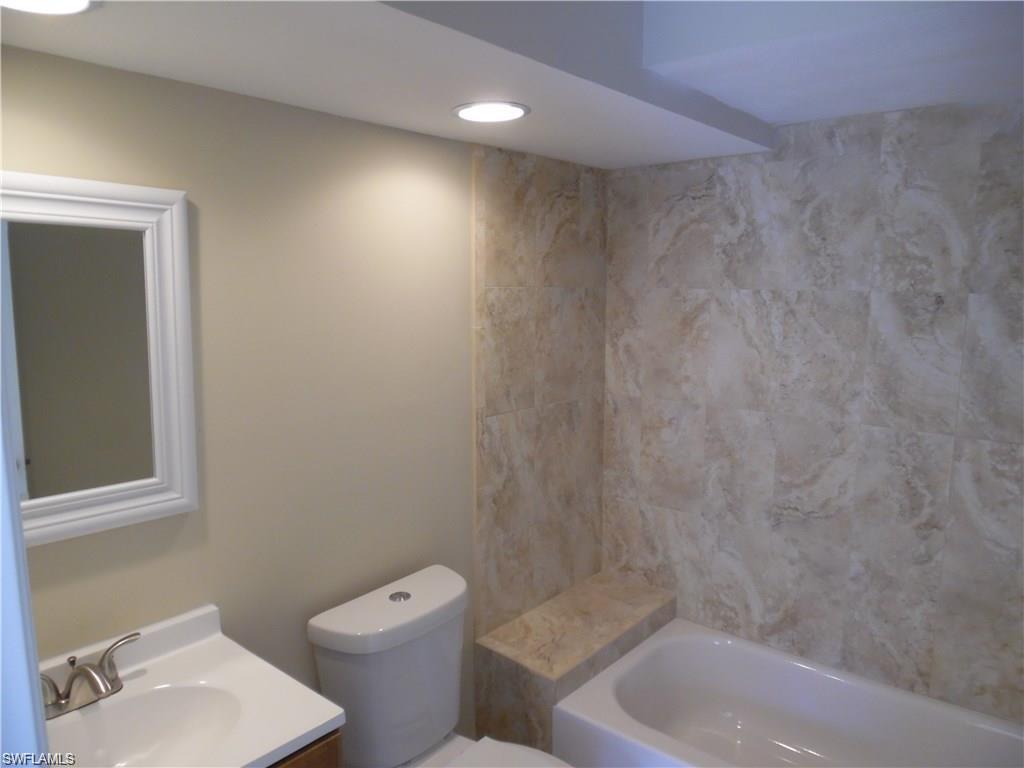 3055 52nd Street Southwest Naples, FL 34116 - Photo 12 of 21 a bathroom with a toilet a sink and bathtub