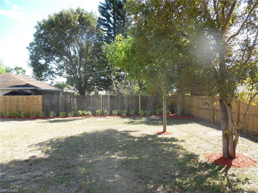 3055 52nd Street Southwest Naples, FL 34116 - Photo 18 of 21 a street view with wooden fence