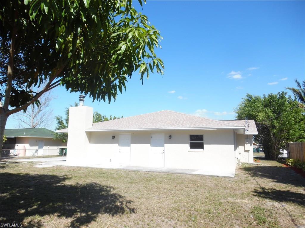 3055 52nd Street Southwest Naples, FL 34116 - Photo 20 of 21 a front view of a house with a yard
