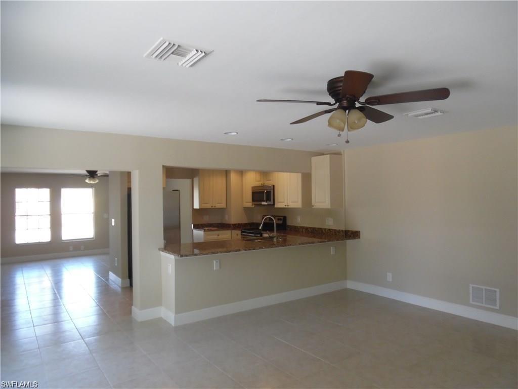 3055 52nd Street Southwest Naples, FL 34116 - Photo 2 of 21 a view of a kitchen with a sink and a window