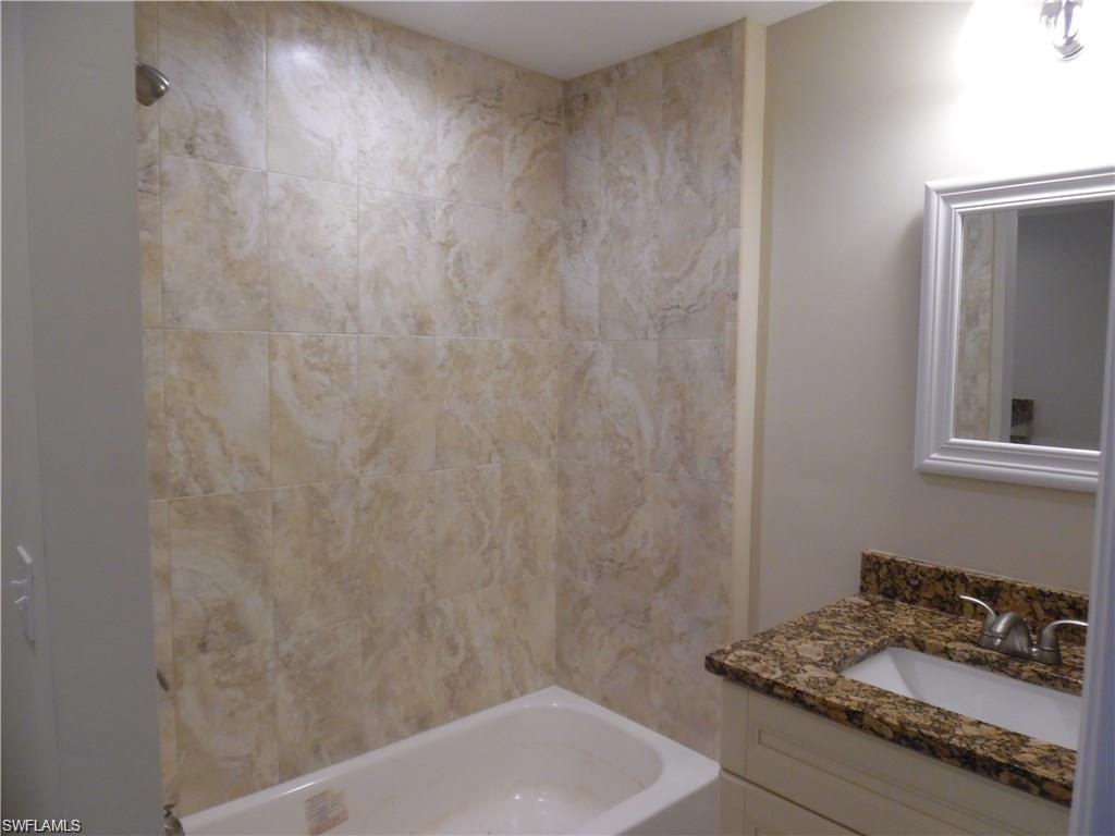 3055 52nd Street Southwest Naples, FL 34116 - Photo 8 of 21 a bathroom with a sink and a mirror