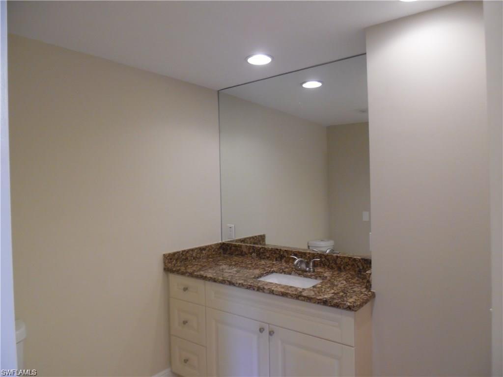 3055 52nd Street Southwest Naples, FL 34116 - Photo 9 of 21 a bathroom with a granite countertop sink and a mirror