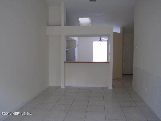 2456 Spring Vale Road Jacksonville, FL 32246 - Photo 3 of 10 an empty room that has a mirror in it