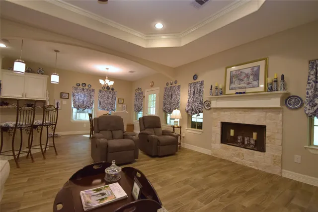 a kitchen with stainless steel appliances granite countertop white cabinets and a stove top oven