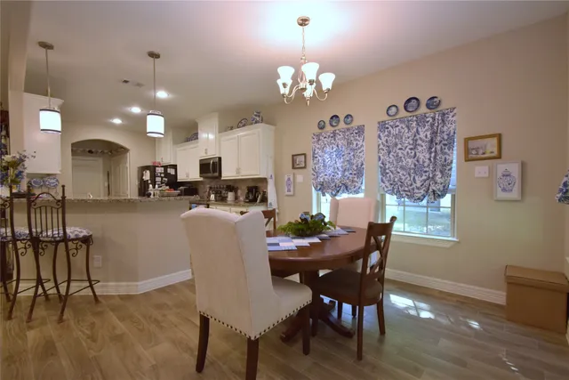 a kitchen with granite countertop a sink a counter top space stainless steel appliances and cabinets